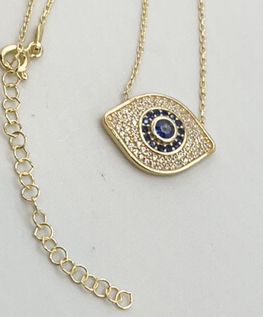 925 Sterling Silver Gold Tone Eye Shaped Evil Eye Necklace: 925 Silver Silver Gold Tone Full crystal Pave Eye-shaped Blue Evil Eye Necklace. 3.8 grams. 18 inches