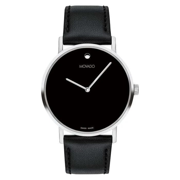 Movado Signature Men’s Watch – Silver Stainless Steel Case with Black Leather Strap: This refined Movado men’s watch embodies timeless elegance with a modern minimalist design. Crafted with a polished silver-tone stainless steel case and a sleek black dial, it delivers the signature