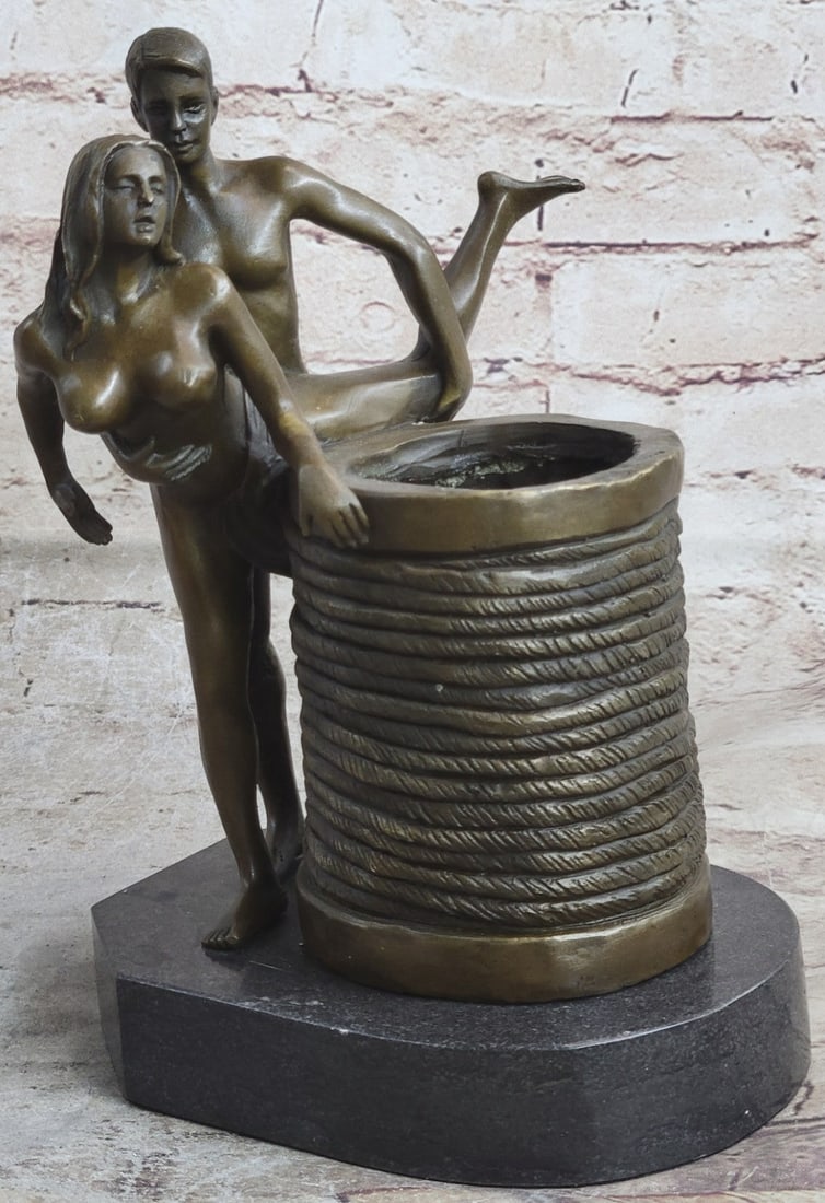 Two Couple Making Love Bronze Sculpture: This erotic Sculpture is an exquisite piece of a beautiful couple in a very evocative pose. The female is sensually touching a barrel as she is getting penetrated by her lover. He grabs her stomach