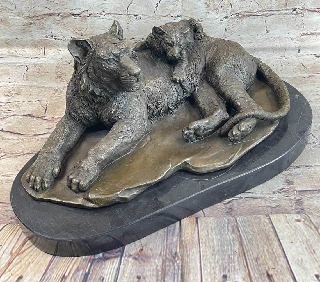 Tiger Wild Life Bronze Sculpture: The mother tigress, with her great bulk and power pacified by the heat, lays under the shade of a tree relaxing with her young cub. The mother peers out intently through the tall shoots of thickets