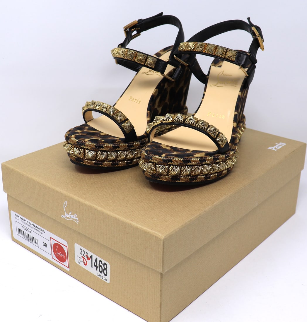 Christian Louboutin Nappa Silk Leopard Pira Ryad 110 Wedge Sandals 36 Black Marron: Preowned Authetic Pair of Christian Louboutin Nappa Silk Leopard Pira Ryad 110 Wedge Sandals 36 Black Marron. The wedge features an adjustable black leather ankle straps and lined in gold pyramid