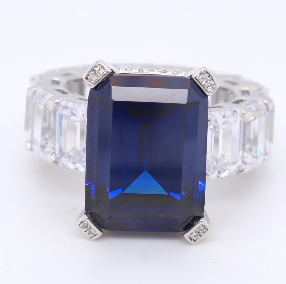 Sterling Silver Emerald Cut Navy Blue Ring with White Cubic Zirconia Band: 925 Sterling Silver Emerald Cut Navy Blue Ring with White Cubic Zirconia Band. Total weight of Ring 15.14 Grams. Ring Size 7.25"