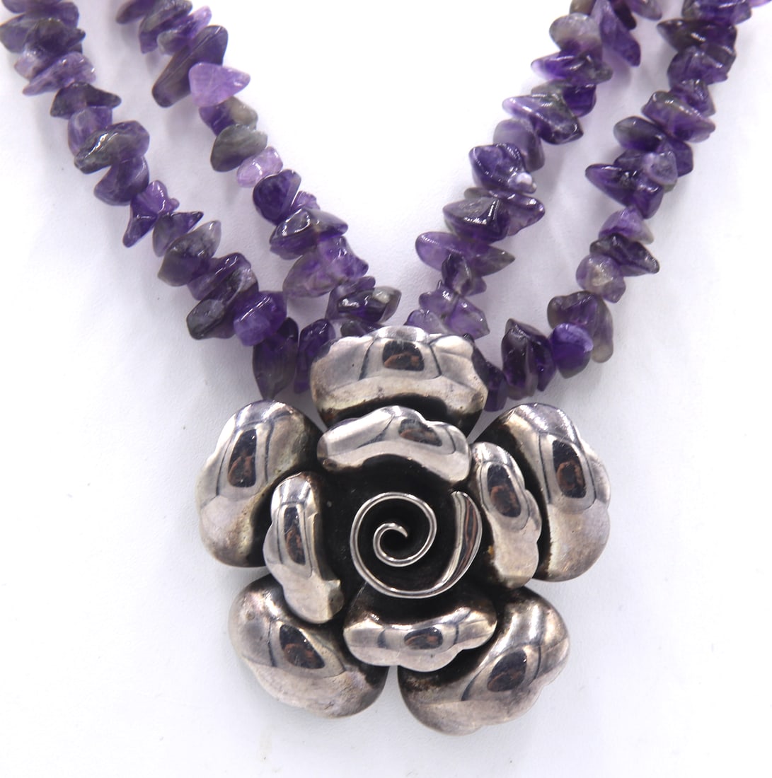Vintage 925 sterling silver signed Flower pendant on Amethyst beaded necklace: Vintage 925 sterling silver signed Flower pendant on adjustable Amethyst beaded necklace. Total weight of necklace is 55.1 grams.