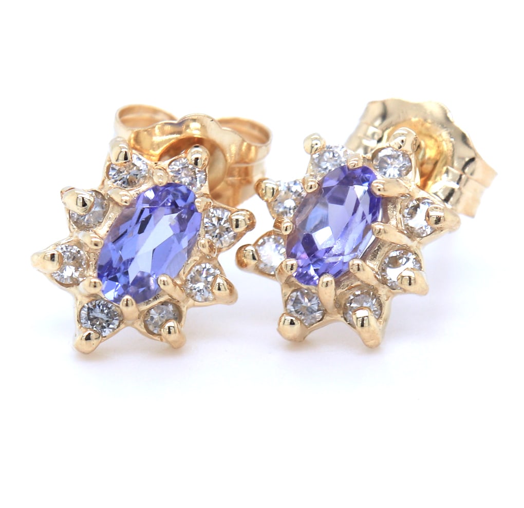 14kt Yellow gold oval Tanzanite and diamond flower earrings: 14kt Yellow gold oval Tanzanite and diamond flower earrings. Total weight of earrings is 1.60 grams.