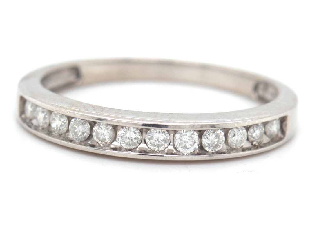 14kt White gold 0.20ctw channel set diamond band: 14kt White gold approximate 0.20ctw channel set diamond band. Color I. Total weight of band is 2.06 grams. Ring size 7.5"