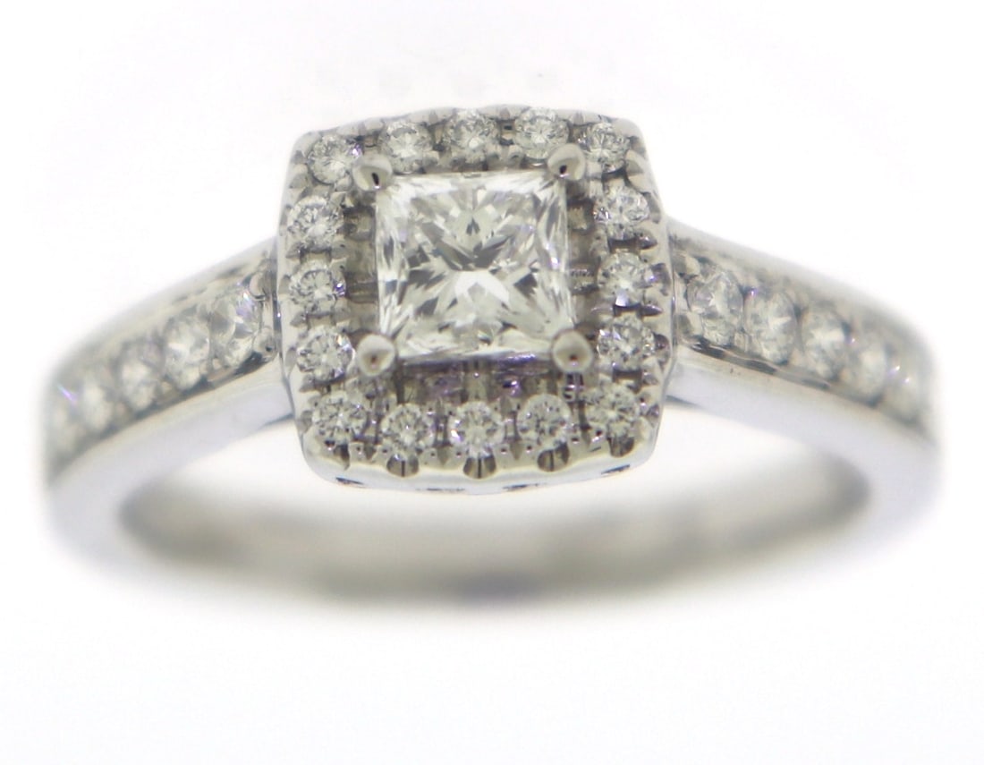 Dazzling 14kt WG Princess Cut Center Diamond Halo Ring: 14kt White Gold Diamond Engagement Ring features 1 Princess Cut Diamond Center approx. 0.50CTW highlighted with 28 Round Brilliant Cut Diamonds set into the halo and down the sides of the ring. The Di