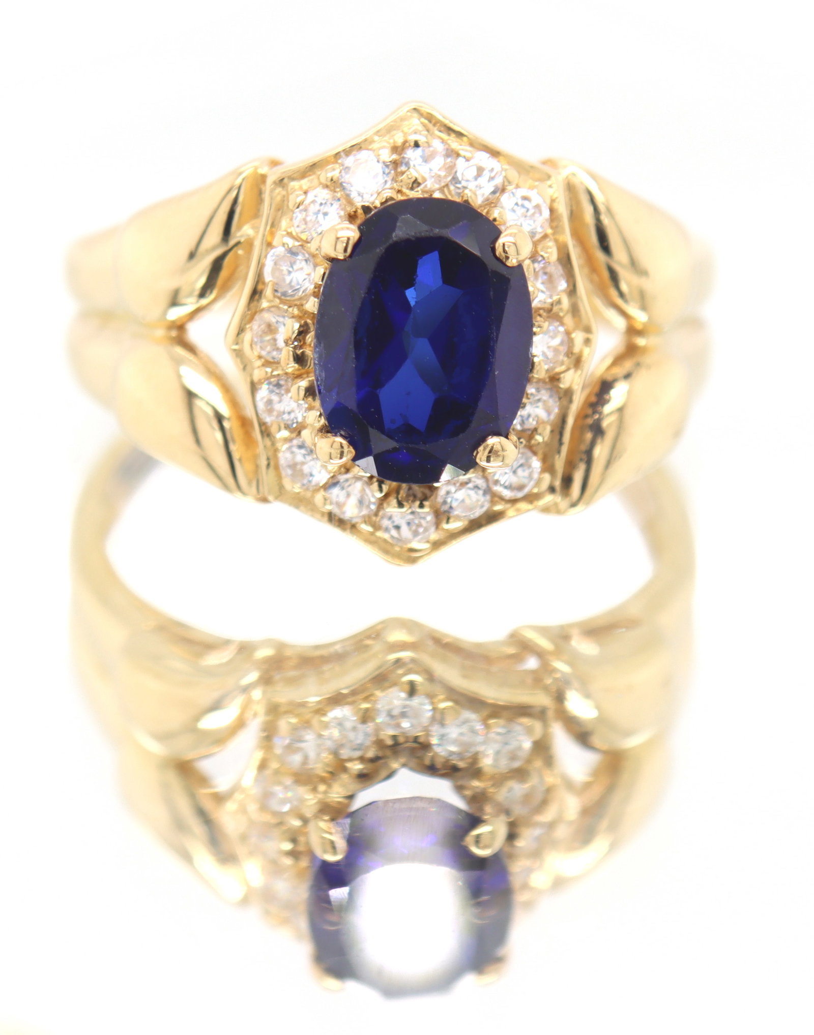 Charming 18kt Synthetic Blue and White CZ Ring: 18kt Yellow Gold Synthetic Blue and White Cubic Zirconia Ring. Total weight of Ring 4.10 Grams. Ring Size 7"