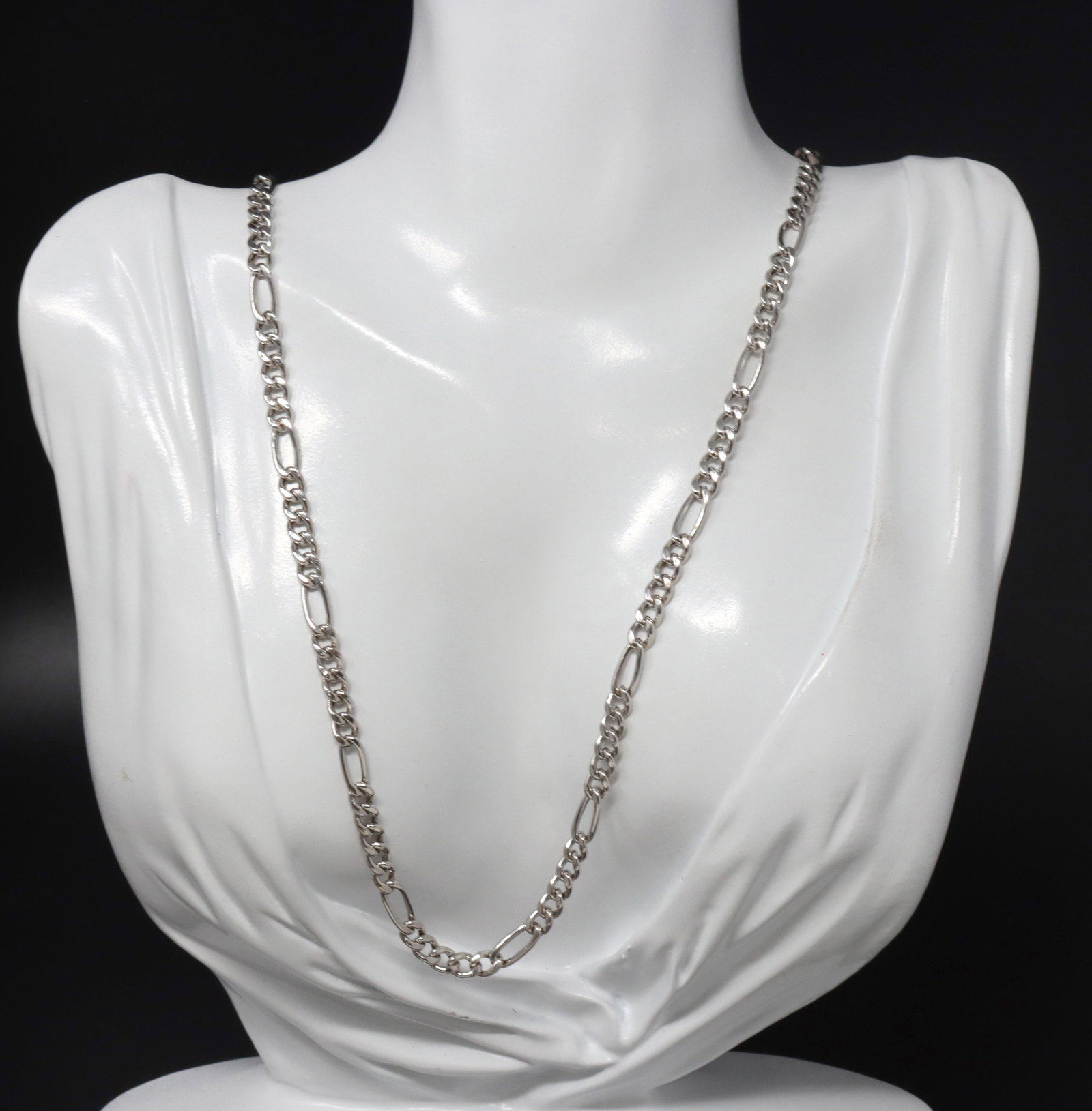18kt White gold Figaro chain necklace: 18kt White gold Figaro 24-inch chain necklace. The total weight of the chain is 16 grams.
