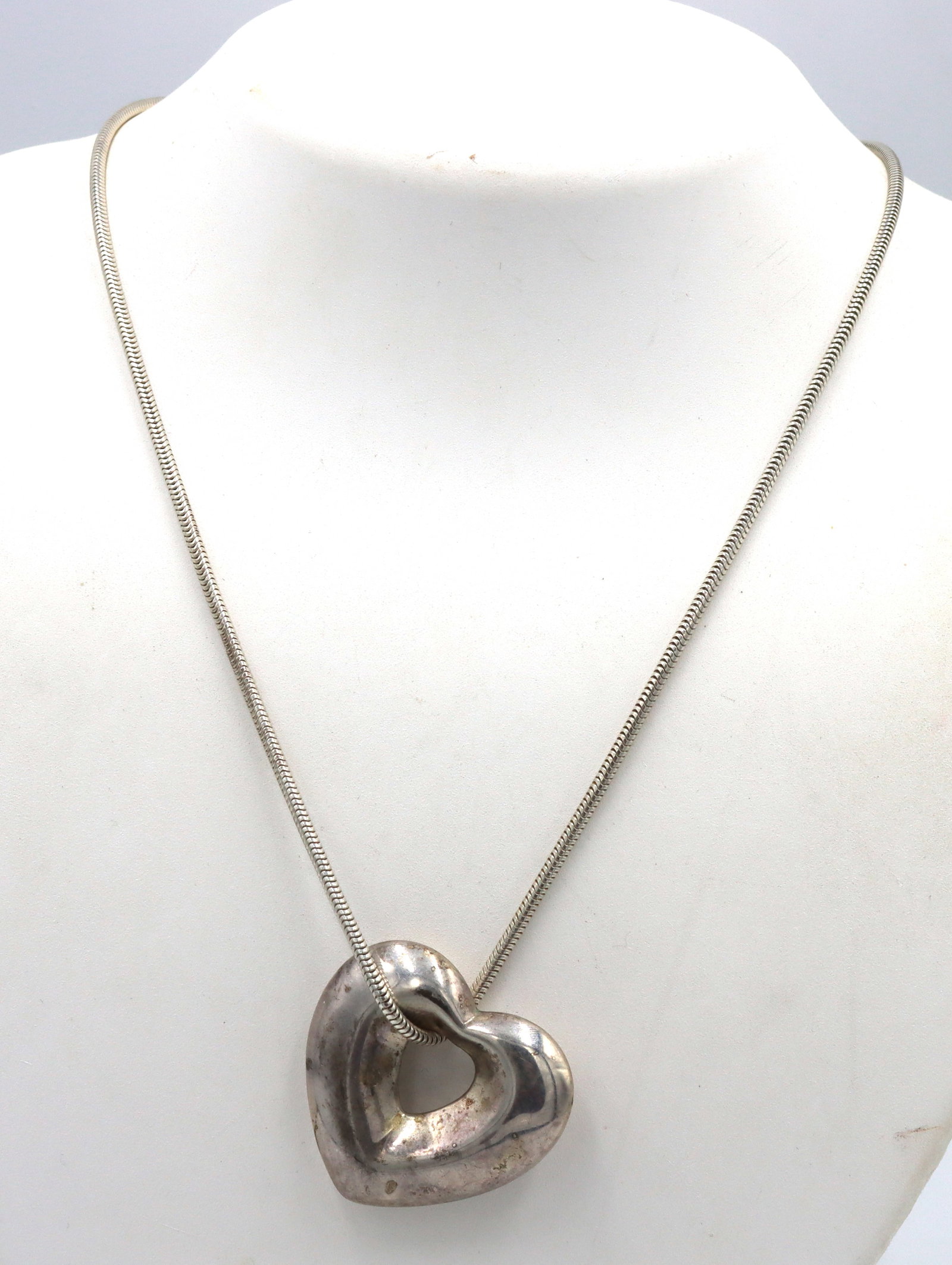 925 Sterling silver heart shaped pendant on snake chain necklace: 925 Sterling silver heart shaped pendant on 30-inch snake chain necklace. The total weight of the necklace is 15.9 grams.