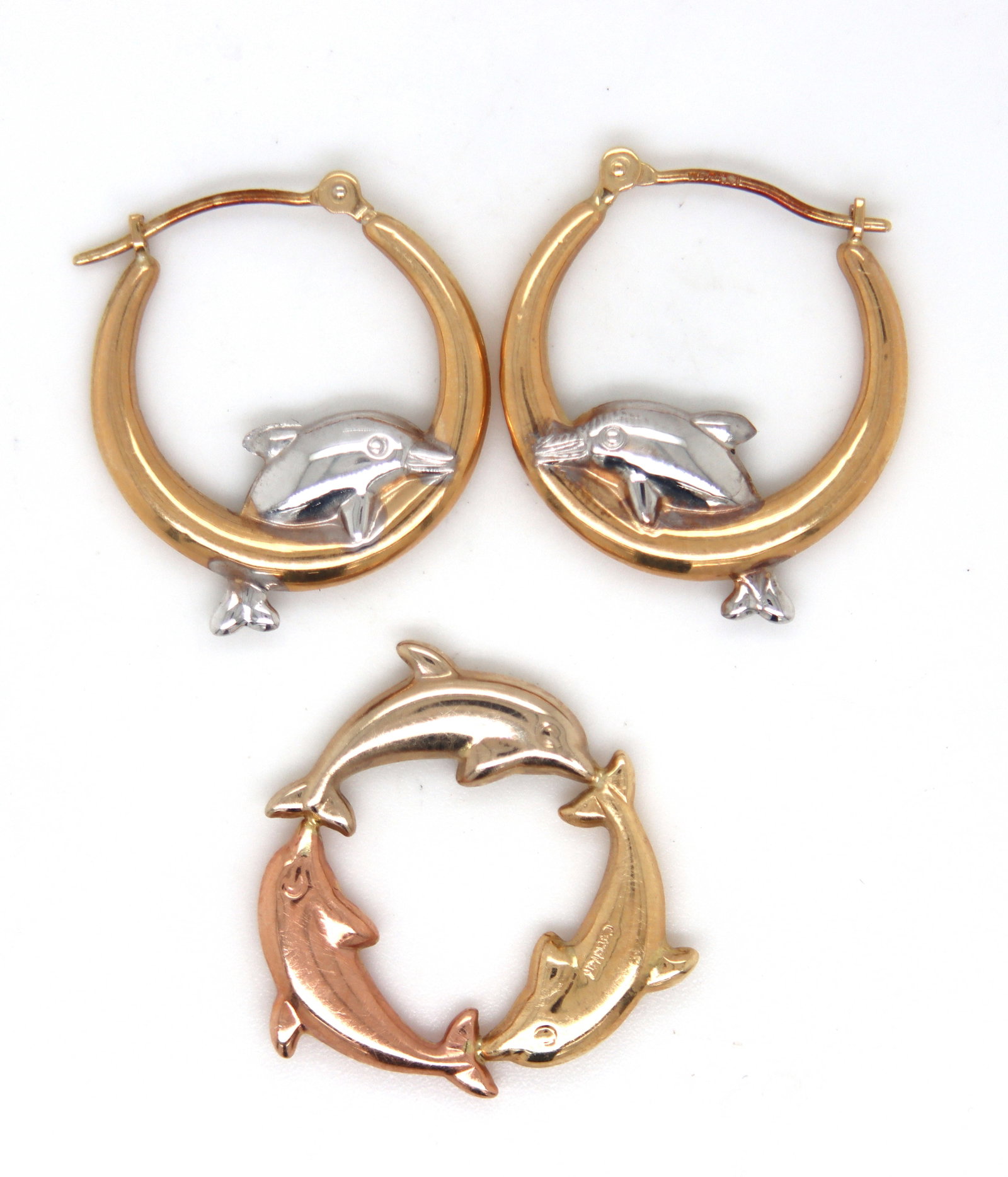 Set of 14kt Yellow gold Dolphin hoop earrings and matching pendant: Set of 14kt Yellow gold Dolphin hoop earrings and matching pendant. The total weight of the set is 1.9 grams.