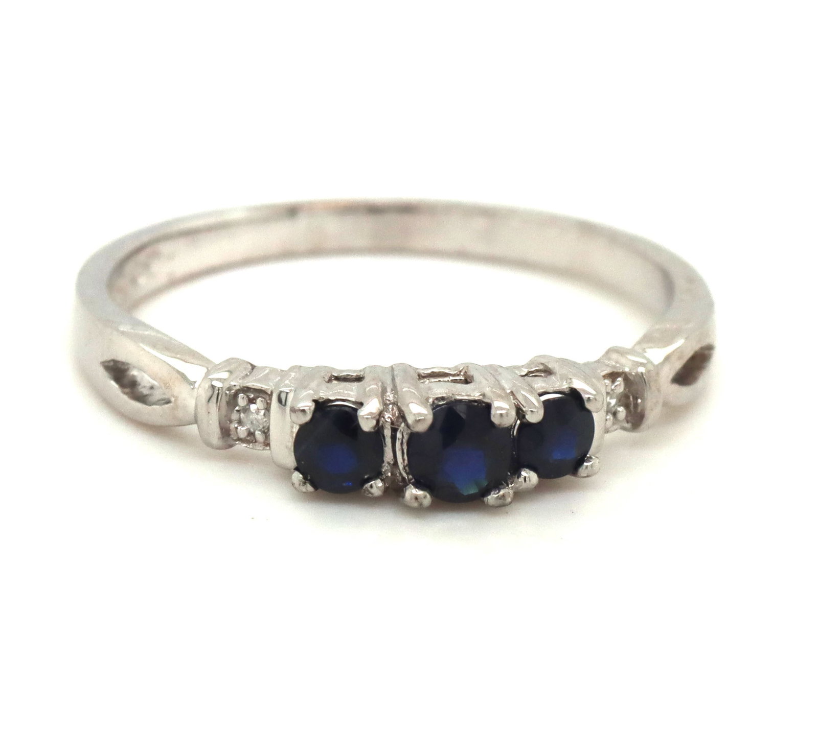 10kt White gold 3 stone sapphire and diamond accent ring: 10kt White gold 3 stone blue sapphire and diamond accent ring. The total weight of the ring is 1.90 grams. Ring size 7.5".