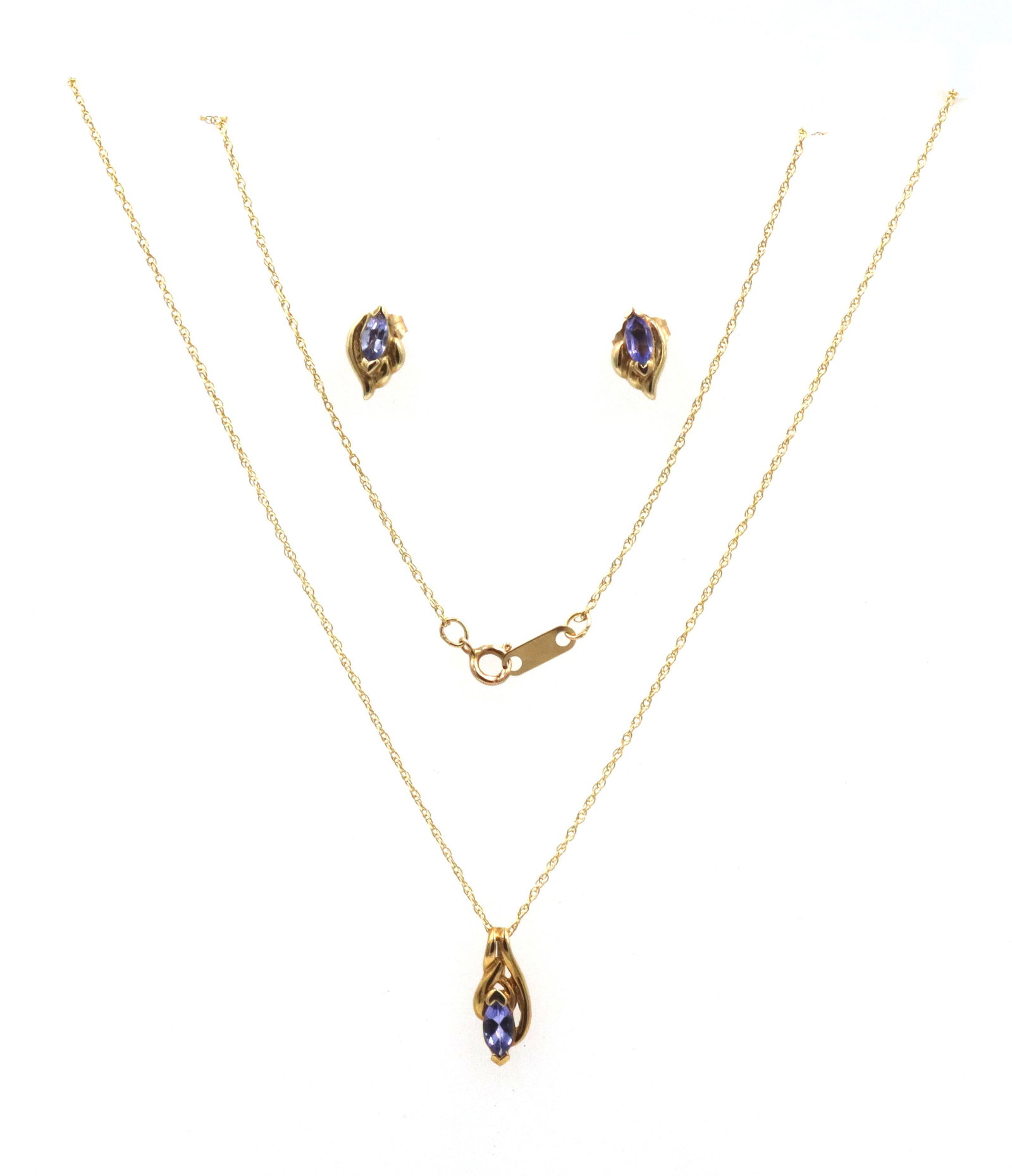 10kt Yellow gold Tanzanite pendant on chain necklace with matching earrings: 10kt Yellow gold Tanzanite pendant on 18-inch chain necklace with matching earrings. The total weight of the set is 2.1 grams.