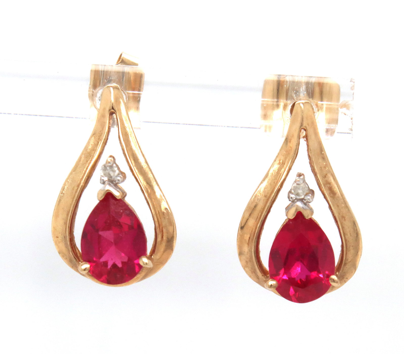 10kt Yellow gold synthetic ruby earrings: 10kt Yellow gold synthetic ruby earrings. The total weight of the earrings is 2.2 grams.
