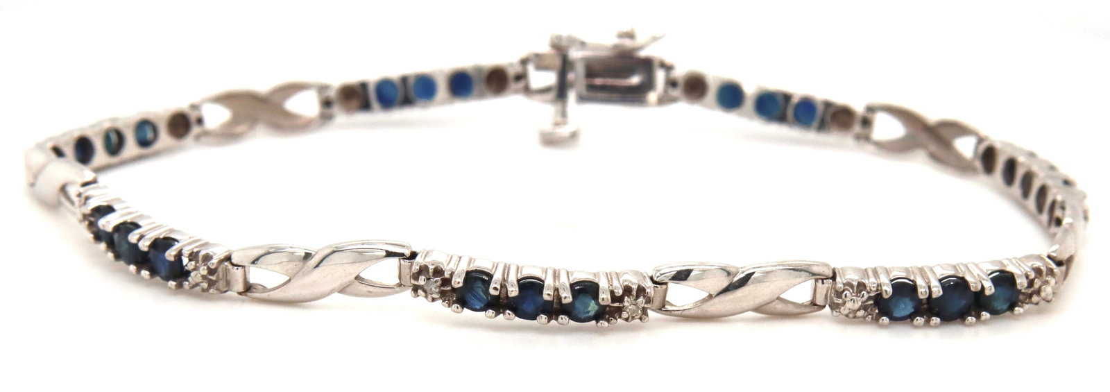 10kt White gold blue sapphire and diamond bracelet: 10kt White gold blue sapphire and diamond 7-inch bracelet. The total weight of the bracelet is 7 grams.