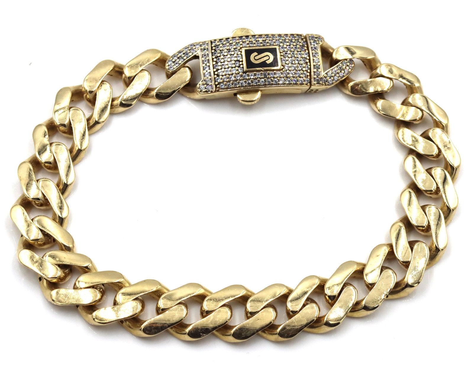 14kt Yellow gold Solid curb bracelet: 14kt Yellow gold Solid curb 8.5-inch bracelet with cubic zirconia clasp. The total weight of the bracelet is 16.4 grams.