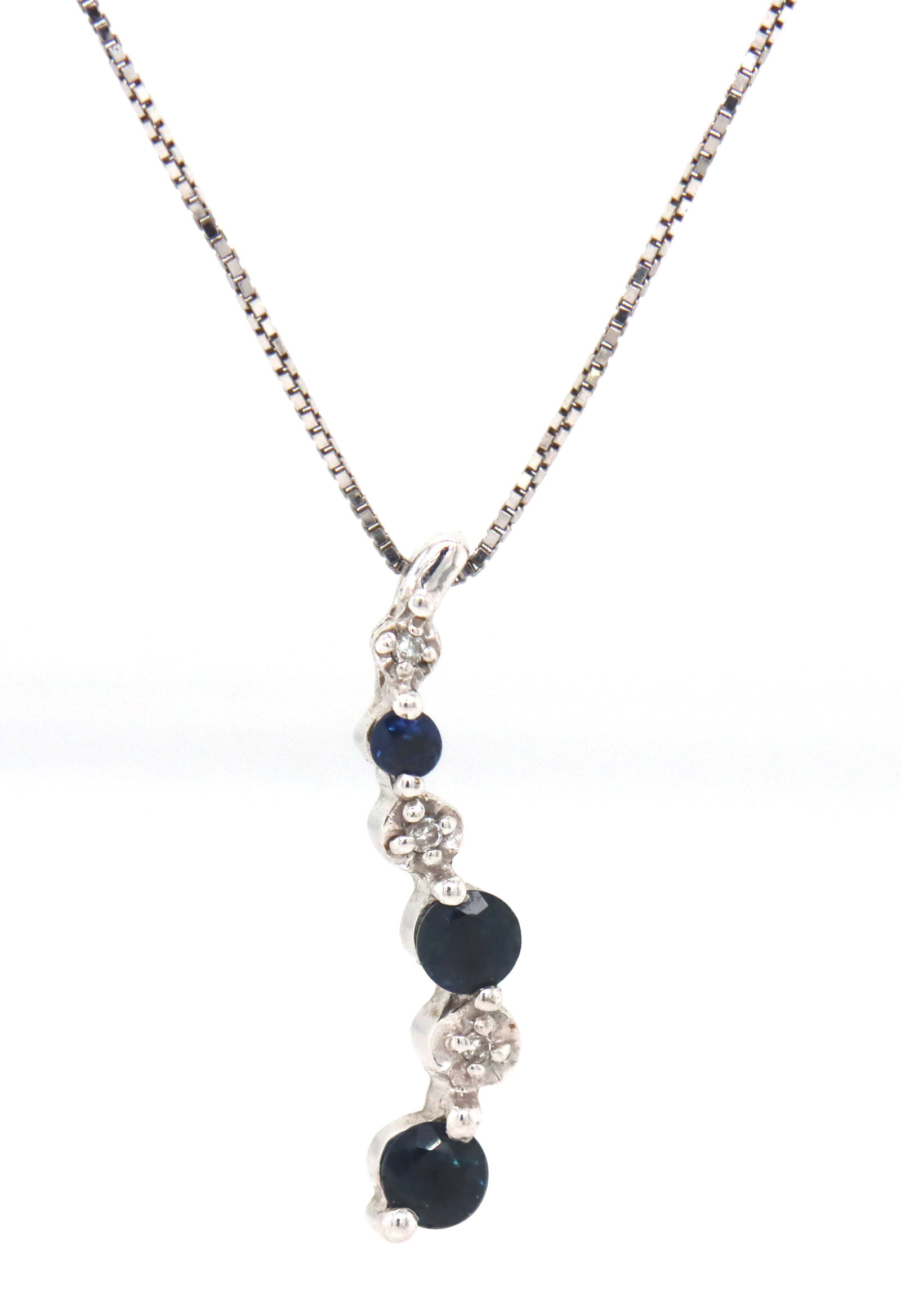 10kt White gold blue sapphire and diamond pendant on chain: 10kt White gold blue sapphire and diamond pendant on 18-inch box chain necklace. The total weight of the necklace is 1.9 grams.