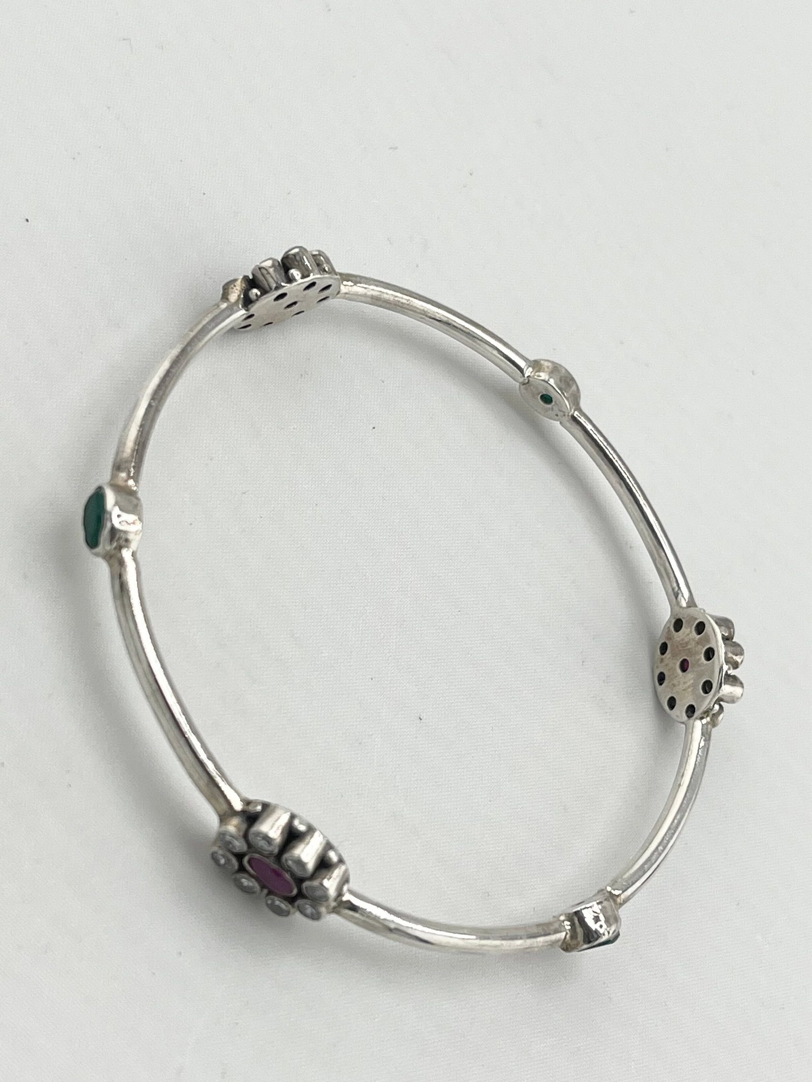 925 Sterling Silver Ruby And Emerald Accents Along The Bangle Bracelet: 925 Sterling Silver Ruby And Emerald With CZ Halo Design Accented Around The Bangle. 15.5 Grams. Size large