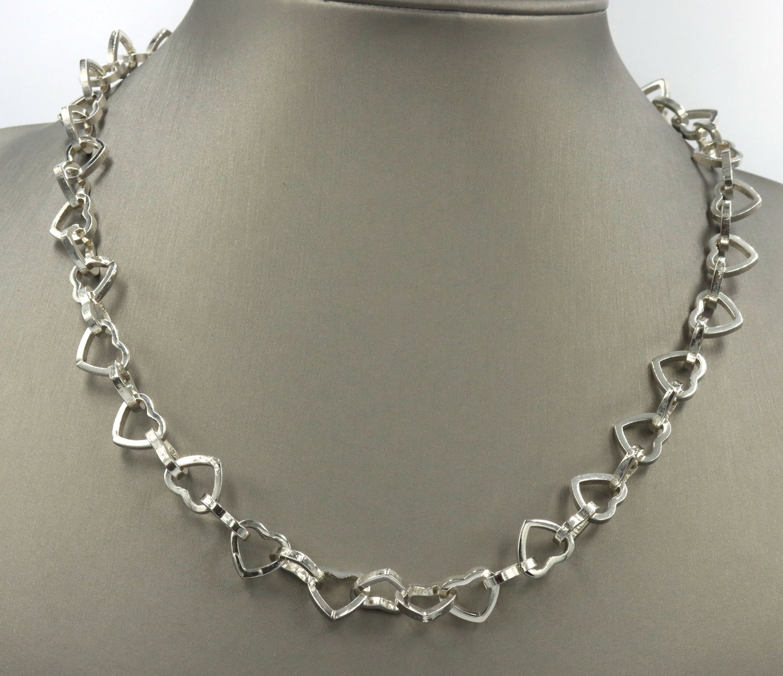 925 Sterling silver heart shaped link chain necklace: 925 Sterling silver heart shaped link 18-inch chain necklace. The total weight of the necklace is 41.55 grams.