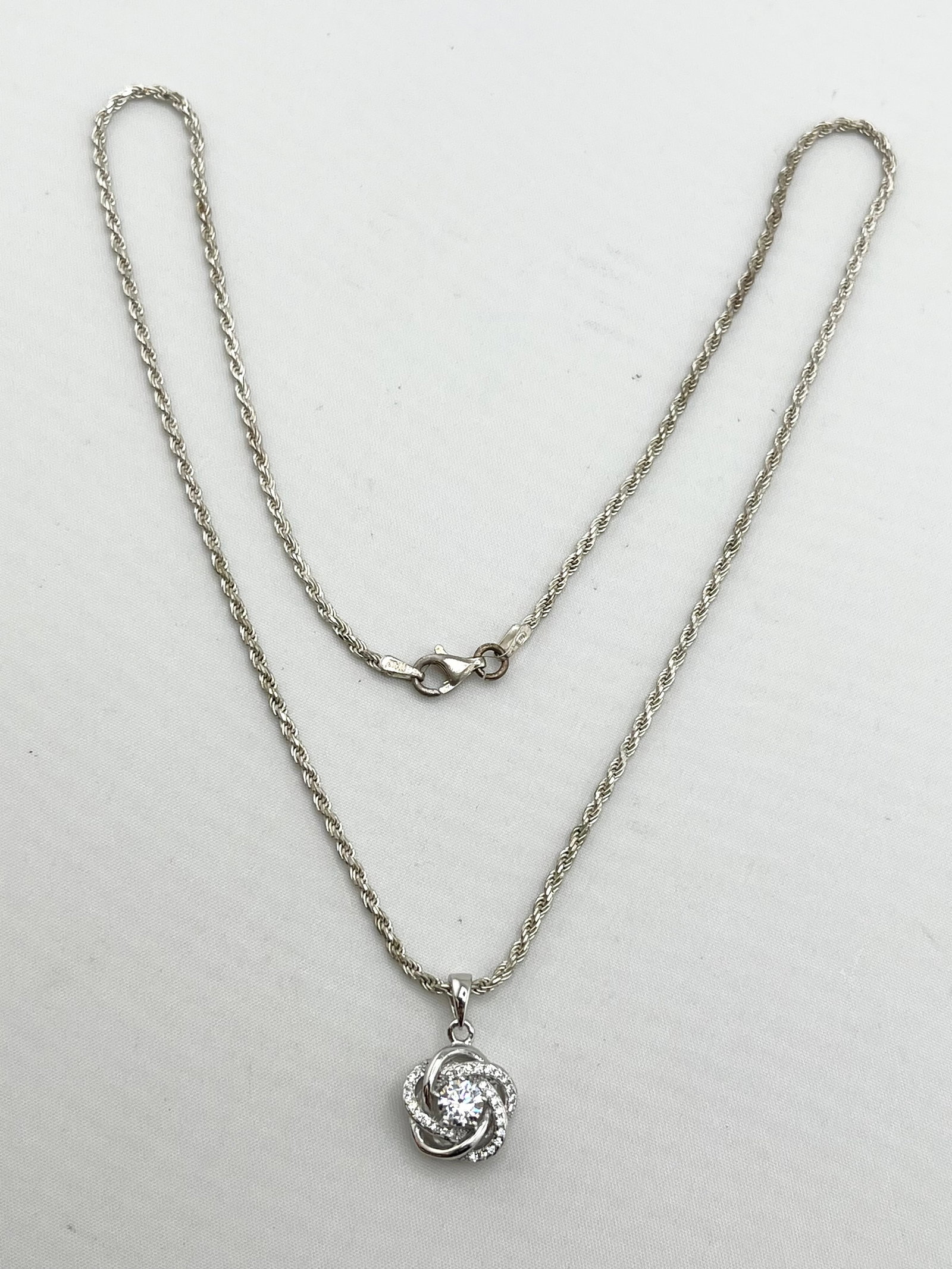 Italian 925 Sterling Silver Infinity Love Knot CZ Pendant with Rope Chain Necklace: Italian 925 sterling Silver Infinity Love knot CZ Pendant with Rope Chain. 7.6 grams. 18 inches Long