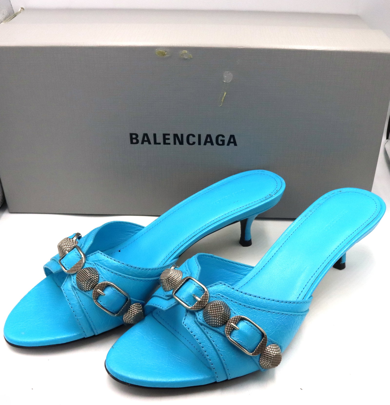 Balenciaga leather studded accents slides: Balenciaga blue leather studded accents slides with buckle closure at uppers. Size 36.5. Made in Italy. Comes with box and dust bag.
