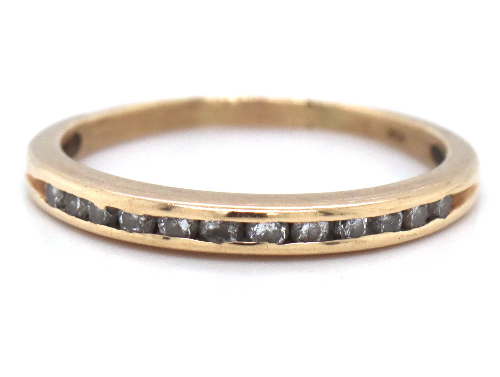 10kt Yellow gold round brilliant cut diamond band: 10kt Yellow gold round brilliant cut diamond band. The total weight of the band is 1.51 grams. Ring size 6.5".