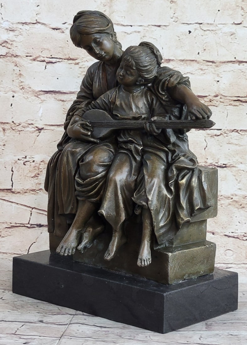 Mother Teaches Her Daughter Bronze Sculpture: A young girl sits against her mother as the mom teaches her how to play the instrument. The young girl is eagerly fiddling with the strings as her mother guides. The mom looks to her with patience and