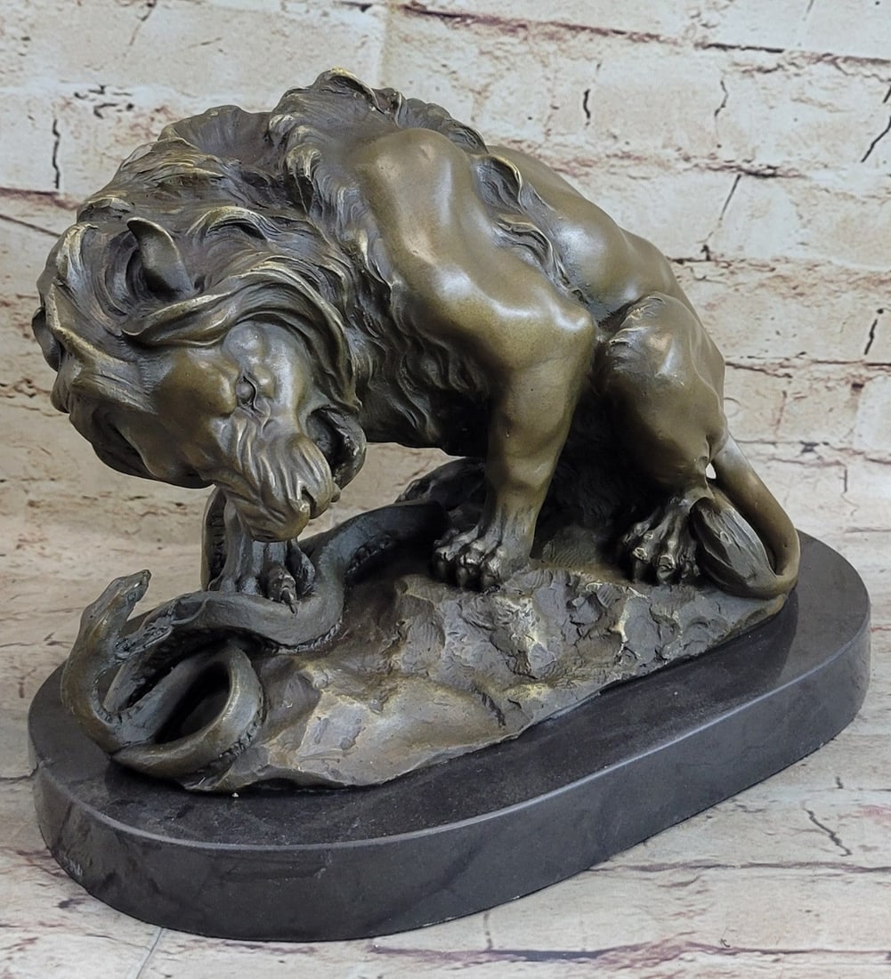 Lion and Snake Bronze Sculpture: This is a beautifully sculpted piece of a lion and a serpent in a stand-off. The majestic male Lion, irritated by the hissing venomous threats of the snake, bends down, cowering over the coiling snake