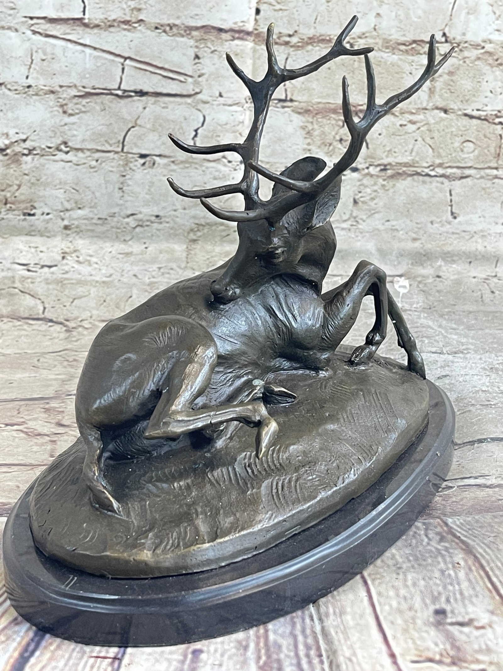 Trophy Antelope Buck Bronze Sculpture: The Bronze is of the highest quality with a luxurious deep brown patina to it. He is relaxing and proud with lovely curled horns. It would make for a great, collectible decorative item for your home.