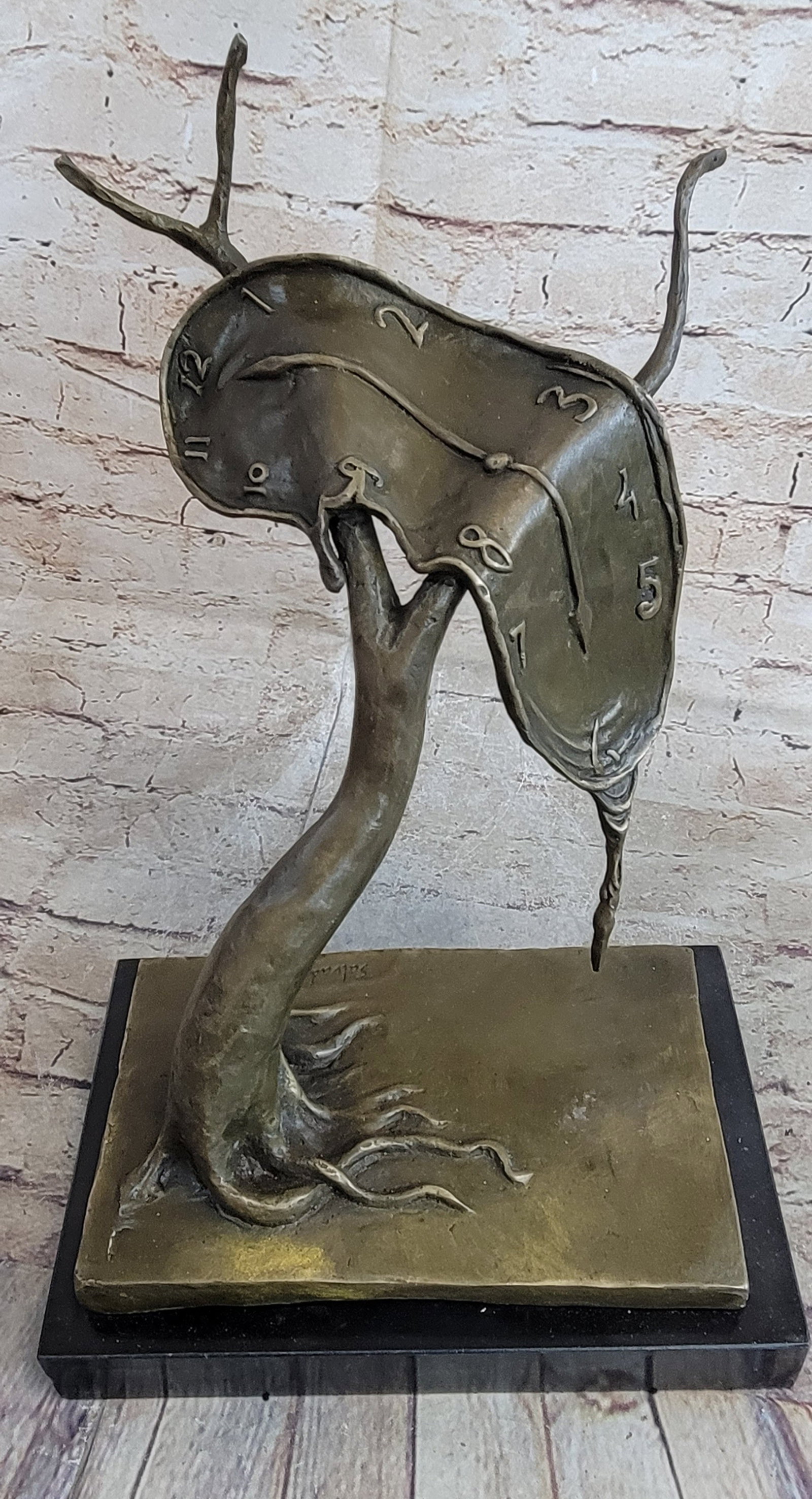 Persistence of Memory Bronze Statue: This bronze Sculpture has isolated the central image of his best-known painting and given it the same title. It is an uncomplicated form composed of a melting watch draped over the branch of a tree.