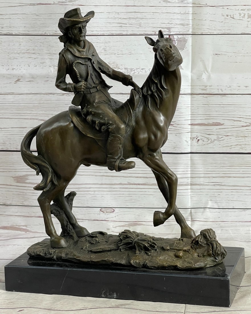 Cowboy with Faithfull Horse Bronze Sculpture: It is the Wild Wild West, This gunslinger, comfortable on his rearing horse, looks over the horse neck to watch ahead for his enemy. He is ready to fire his weapon if need be as he travels hurriedly