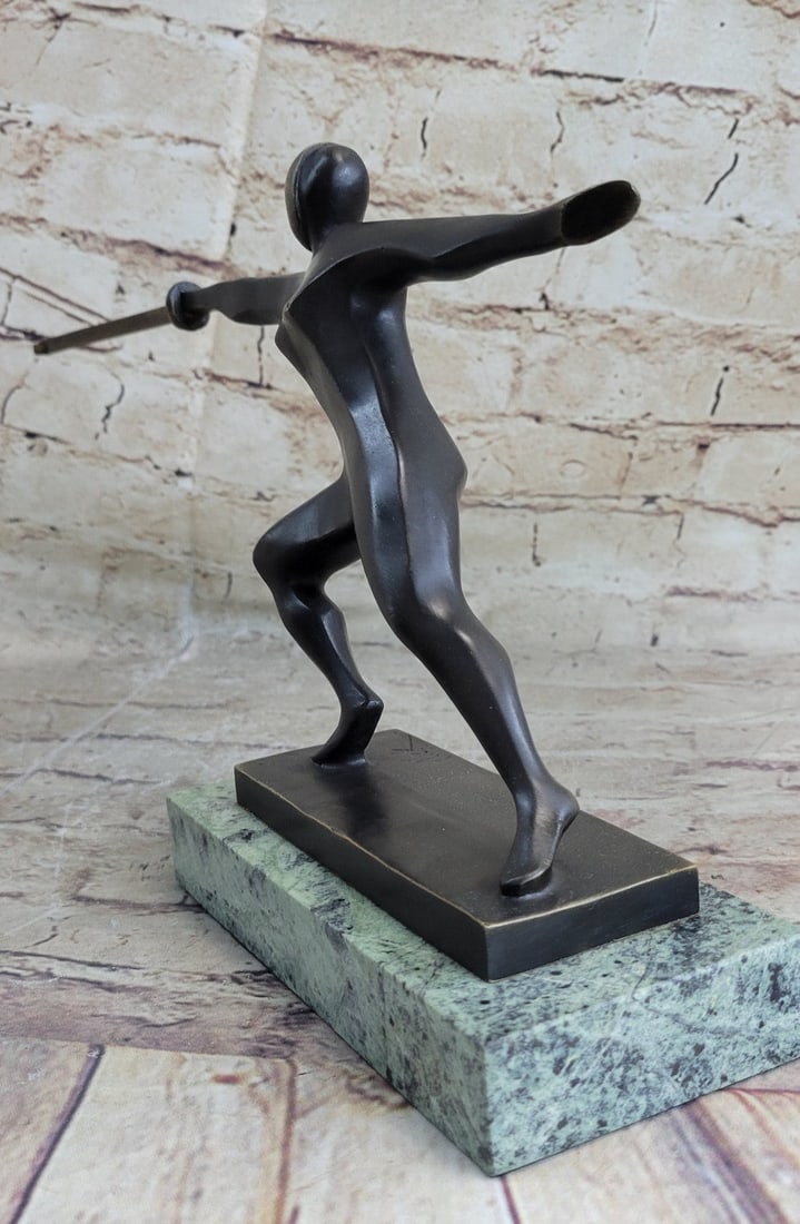 Brown Patina Bronze Statue: This Sculpture shows a fencer who is very focused to achieve his victory over his opponent. The fencer stands with his facing forward, a strong attacking move. This Sculpture was crafted using the los
