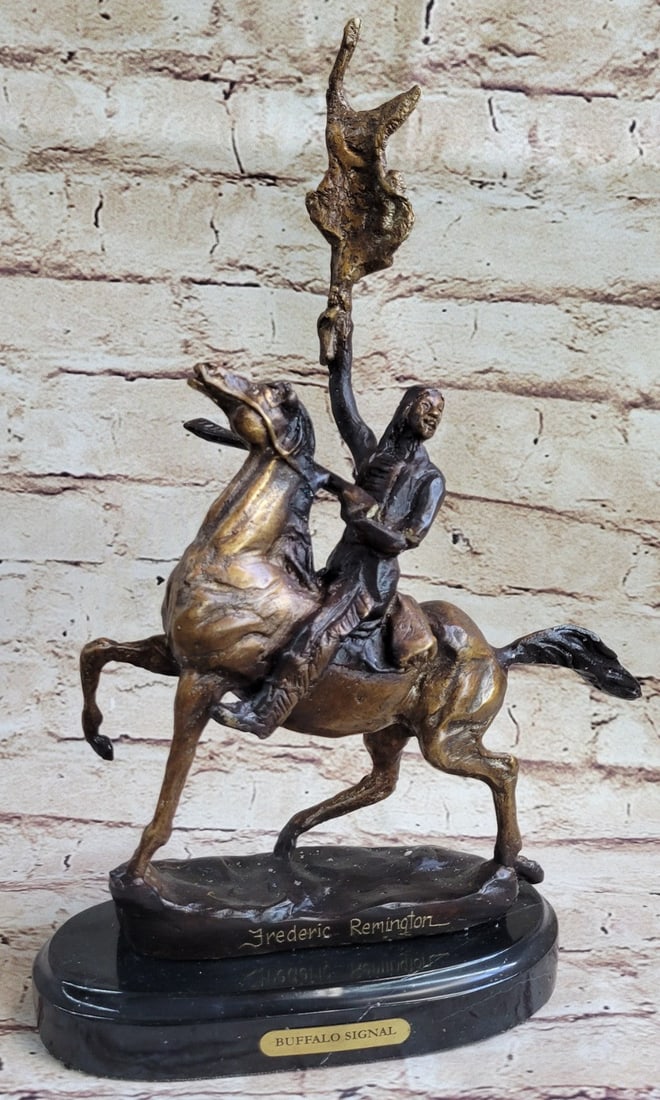 Native American Bronze Sculpture: The Buffalo Signal captures a Native American warrior who sits triumphantly atop his horse. He holds his head high with defiance and triumph set in his intense eyes. Above his head, he holds the hide 