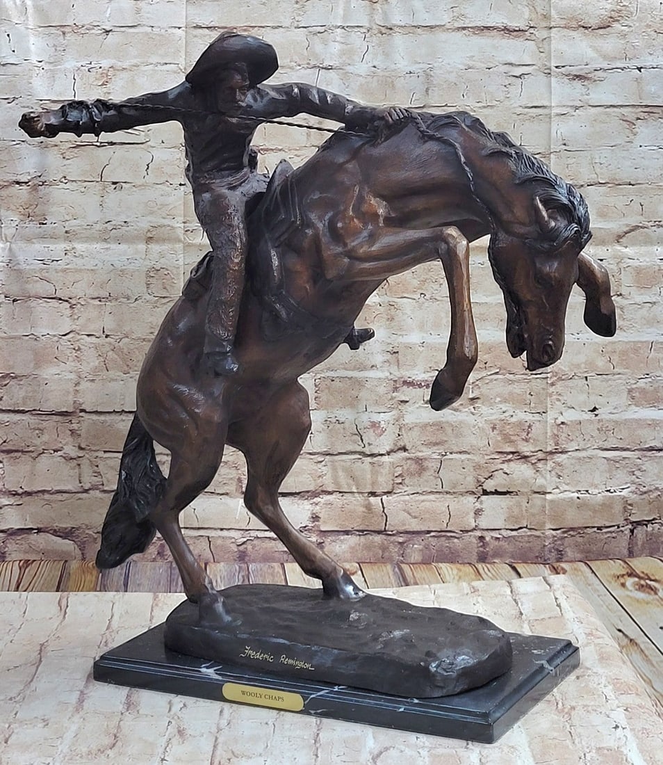 Wooly Chaps Bronze Sculpture: A seasoned cowboy courageously rides his wild horse. His body rolls with every move of the horse. He is dressed in a shirt, chaps, and boots. The horse saddle stays secure as he kicks leaps. Though th