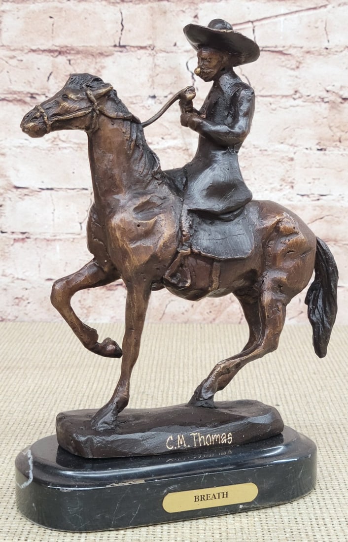 Horse and Cowboy Bronze Sculpture: A seasoned cowboy courageously rides his wild horse. He is bucked by his uncontrollable stallion but his grip on the reins never breaks. His body rolls with every move of the horse. He is dressed in a