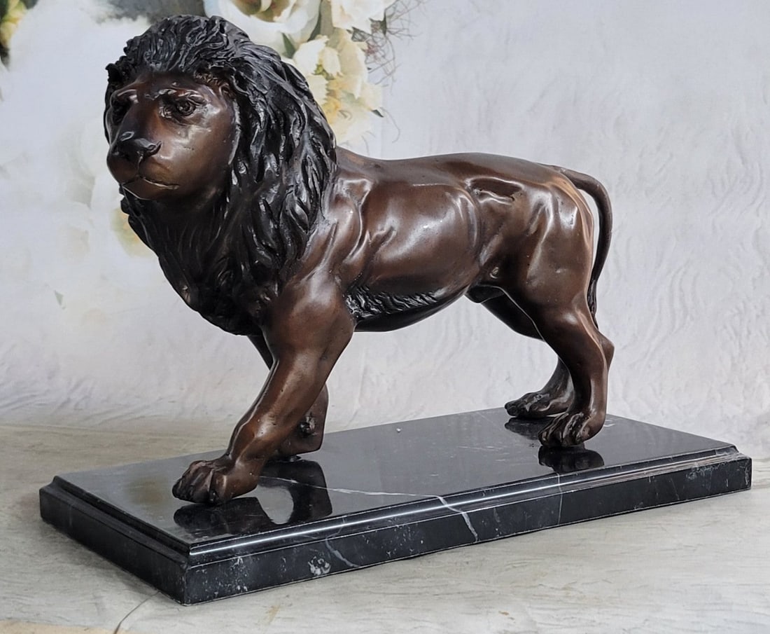 King of Jungle Lion Bronze Sculpture: With piercing eyes and a serious look, this lion is intimidating just by a glance. His mane is full and covers his neck and travels down to his underside trailing off into the sides of his stomach. Th