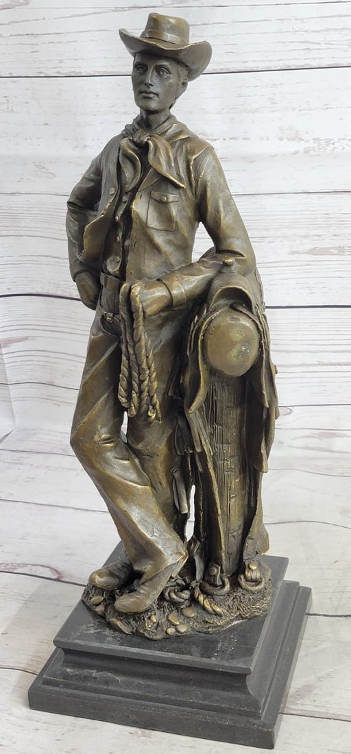 Cowboy with Rope Bronze Sculpture: This is a sculpture of a classic cowboy. He wears his cowboy hat and his handkerchief loosely tied around his neck and holds a rope in his hand. On his feet, He wears boots which his jeans cover in be