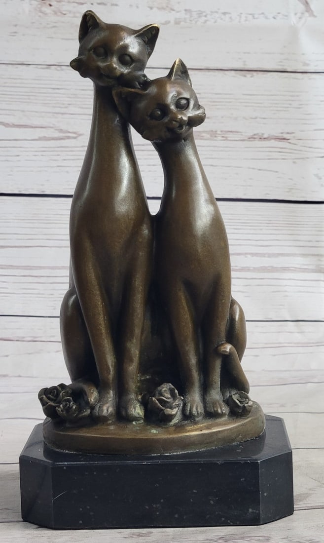 Two Cat Bronze Figurine: Two slender cats sit next to each other purring and staring out amiably and saucer-eyed. Rosebuds litter the ground where their dainty paws meet and their curled tails twine. Some attributes