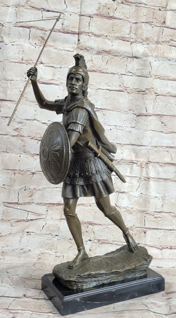 Roman Legion Soldier Warrior Bronze Sculpture: The Roman legion soldier stands in full ancient regalia. Upon his head, he wears a gale which was a soldier helmet made of Bronze. He wears metal armor around his torso over the knee-length tunic. A f