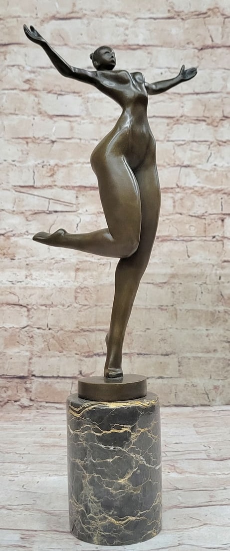 Nude Girl Bronze Sculpture: An abstract beauty poses for a portrait. She stretches her long round body. She kneels and curls an arm upward. Like a classic pinup, she pushes her chest out, tilts her head up, and is ready for her