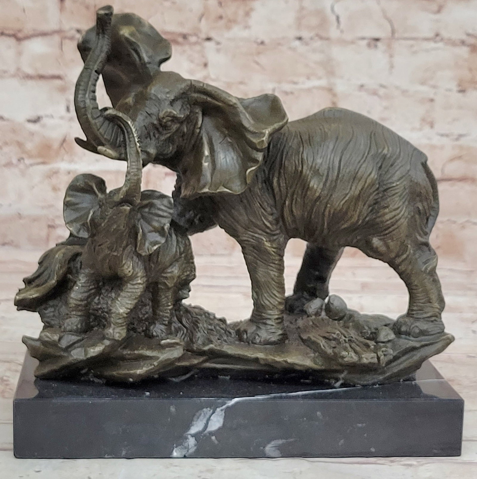 Elephant with Baby Wildlife Bronze Sculpture: The Elephant family celebrates the unbreakable bond between mother and child. the artist captures a sweet moment between mother and child and uses the lost-wax method to cast these figures from