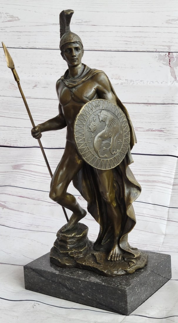 Roman Warrior Bronze Sculpture: The Roman legion soldier stands looking to the horizon of a scarred battlefield. He is nude except for wearing some items of soldier regalia. Atop his head, he wears a galea, which is a soldier hat. D