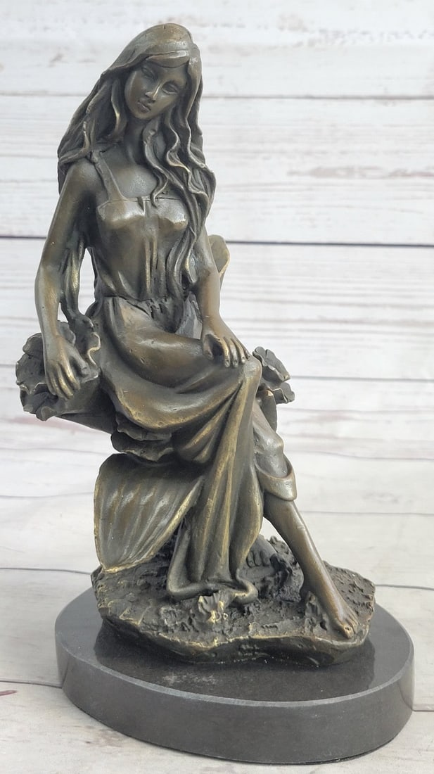 Tulip Garden Bronze Sculpture: This beautiful woman sits in the midst of a gorgeous flower garden and picked a bunch of different once for her home. She has this amazing long yet sexy dress, that reveals her legs. The beauty sits l