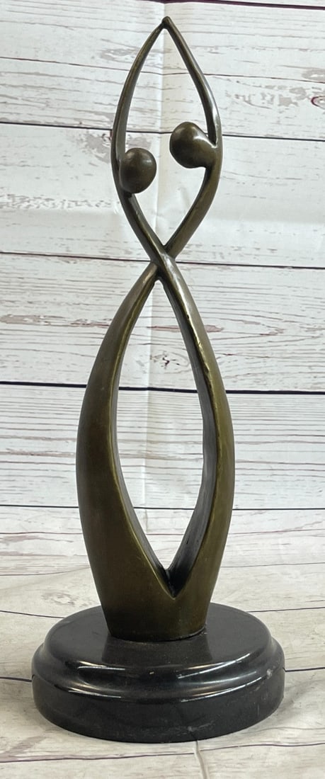 Two Beings Becoming One Bronze Sculpture: An abstract creation portraying two beings becoming one. The piece takes on the shape of the infinity symbol suggesting an eternal unity between the two. This one hundred percent bronze sculpture