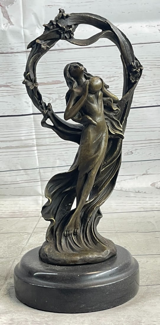 Dream Goddess Bronze Sculpture: This dream goddess Stands under a ring of bliss that is filled with loving warm energy. Her beautifully long dress wanders away in the wind, almost as if it is doing a small dance to the dreams of