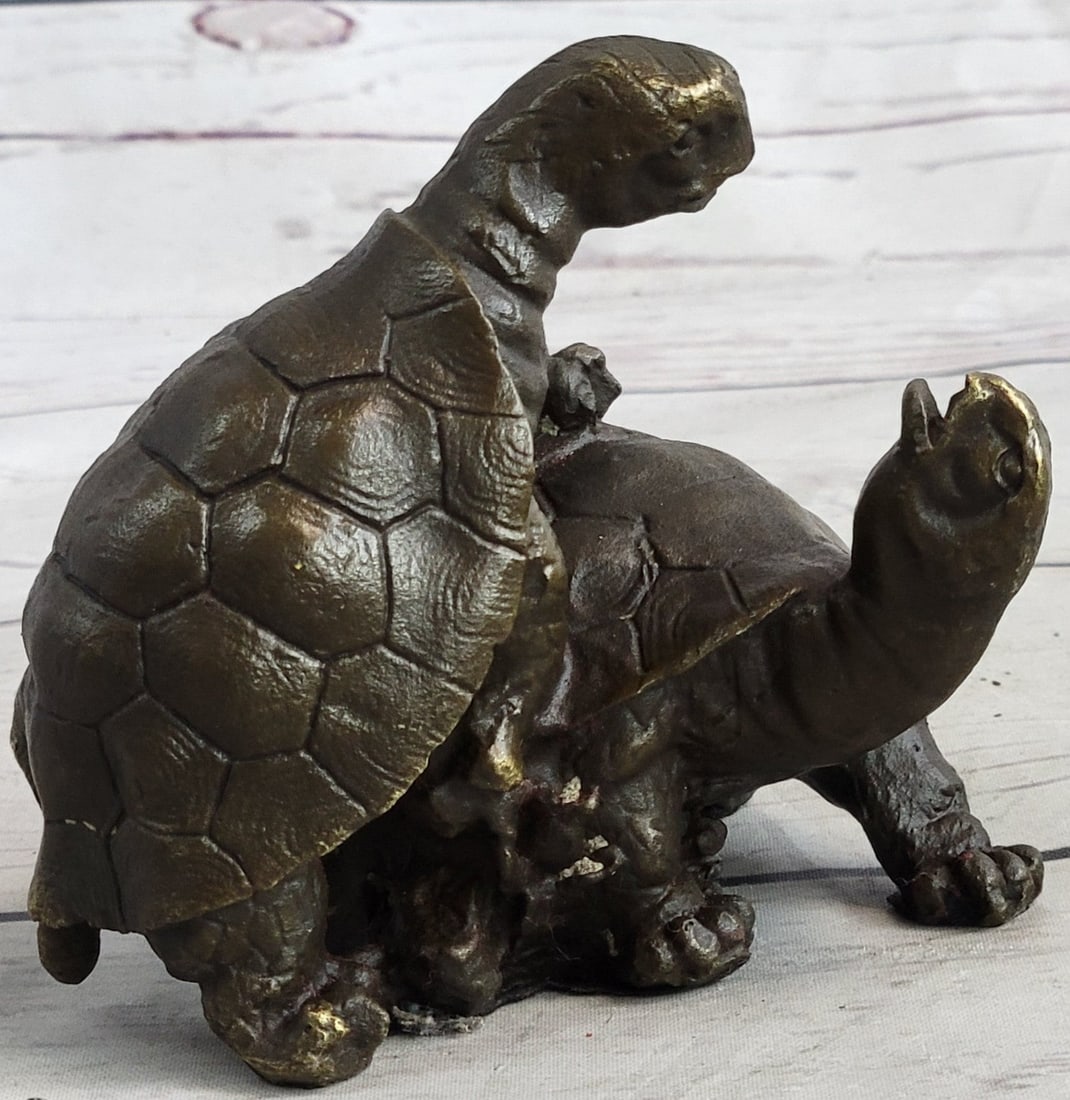 Turtle Reptile Garden Bronze Sculpture: This adorable figurine features an adorable representation of two turtles sharing a loving moment. The first turtle is crawling on top of the second one as the second turtle looks back at him. Western