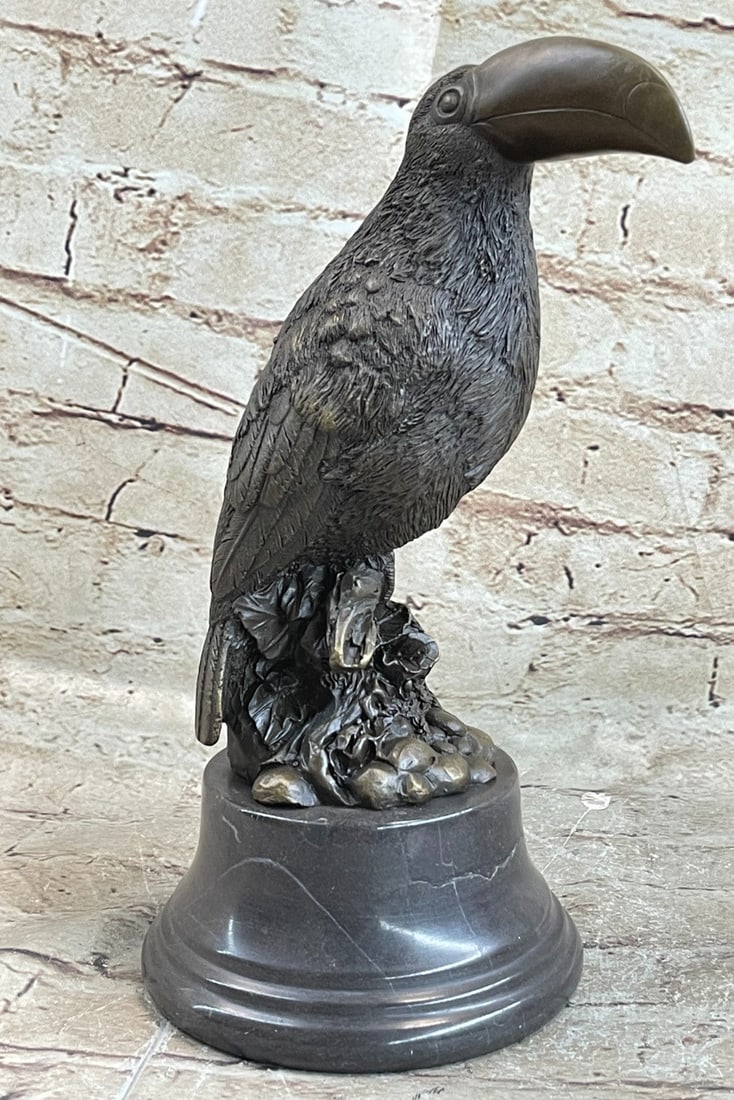 Bird Genuine Bronze Statue: A stoic bird sits high, looking out at the land below. This would make a fine addition to any bird lover collection. With a beak-shaped like the unusual Toucan, this Sculpture will bring personality t