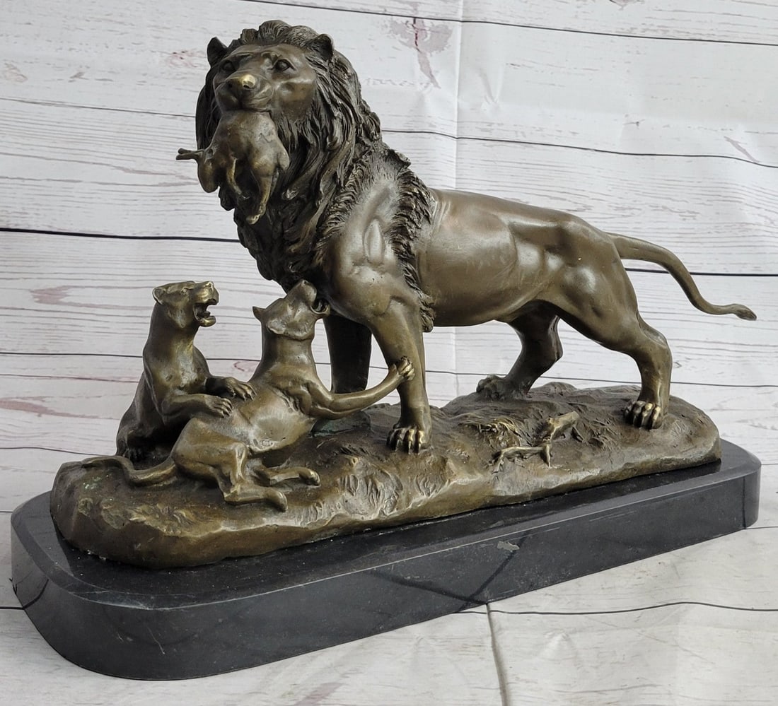 Male Lion with Cubs Bronze Figurine: The viewer comes across a peculiar scene as the male lion, not the lioness, has returned to his cubs carrying in his mouth a hare to have as a meal. He looks out to the distance wondering about his pr