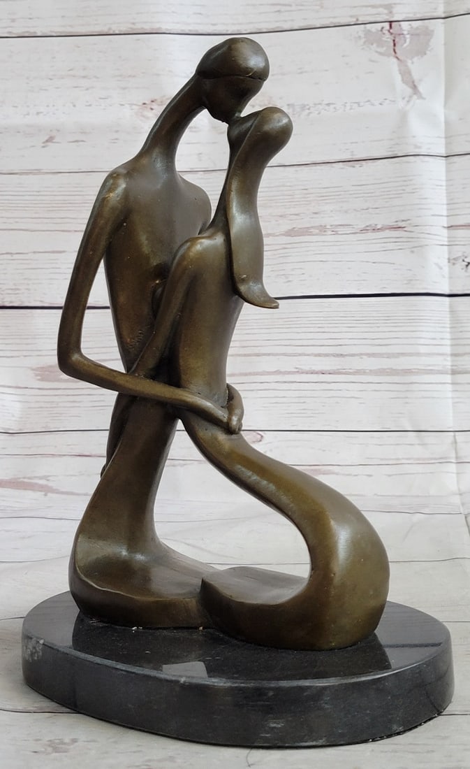 Two Lovebirds Sharing a Kiss Bronze Sculpture: An abstract sculpture of two lovebirds sharing an intimate kiss. Their arms are wrapped around each other. In this wonderful representation of affection, the lower half of the piece forms a heart