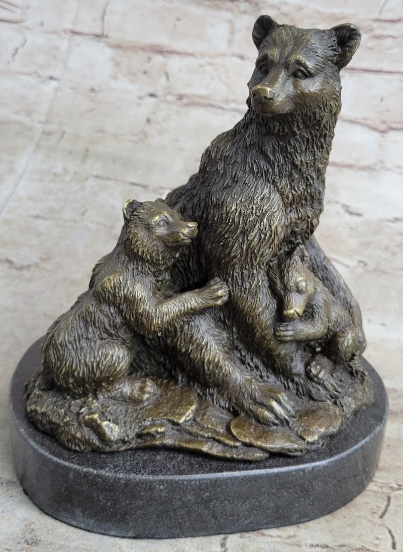 Bear with her two Cubs Bronze Sculpture: The mother bear sits upright with her two dear cubs nestled in the warmth of her fur and love. She stares out from under knitted brows with an expression of happiness as both her cubs suspend their