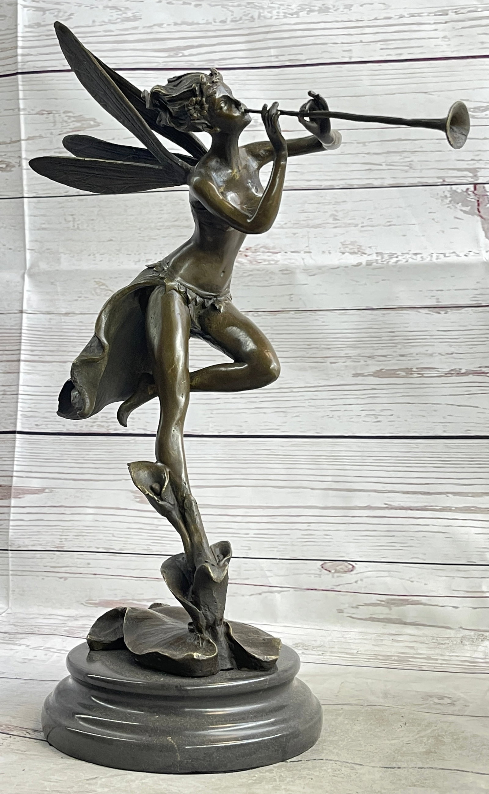 Lily on the Pond Bronze Sculpture Fairy: A Fairy Flies from Heaven. She hails from the heavens and fights for the salvation of our world as well as his from darkness of any form. She wears a robe and sandals, carrying a message with her